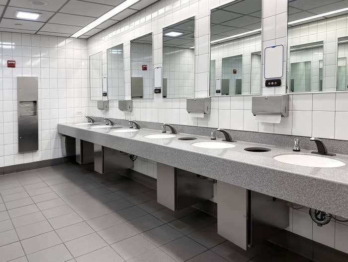 A row of several sinks in a public bathroom