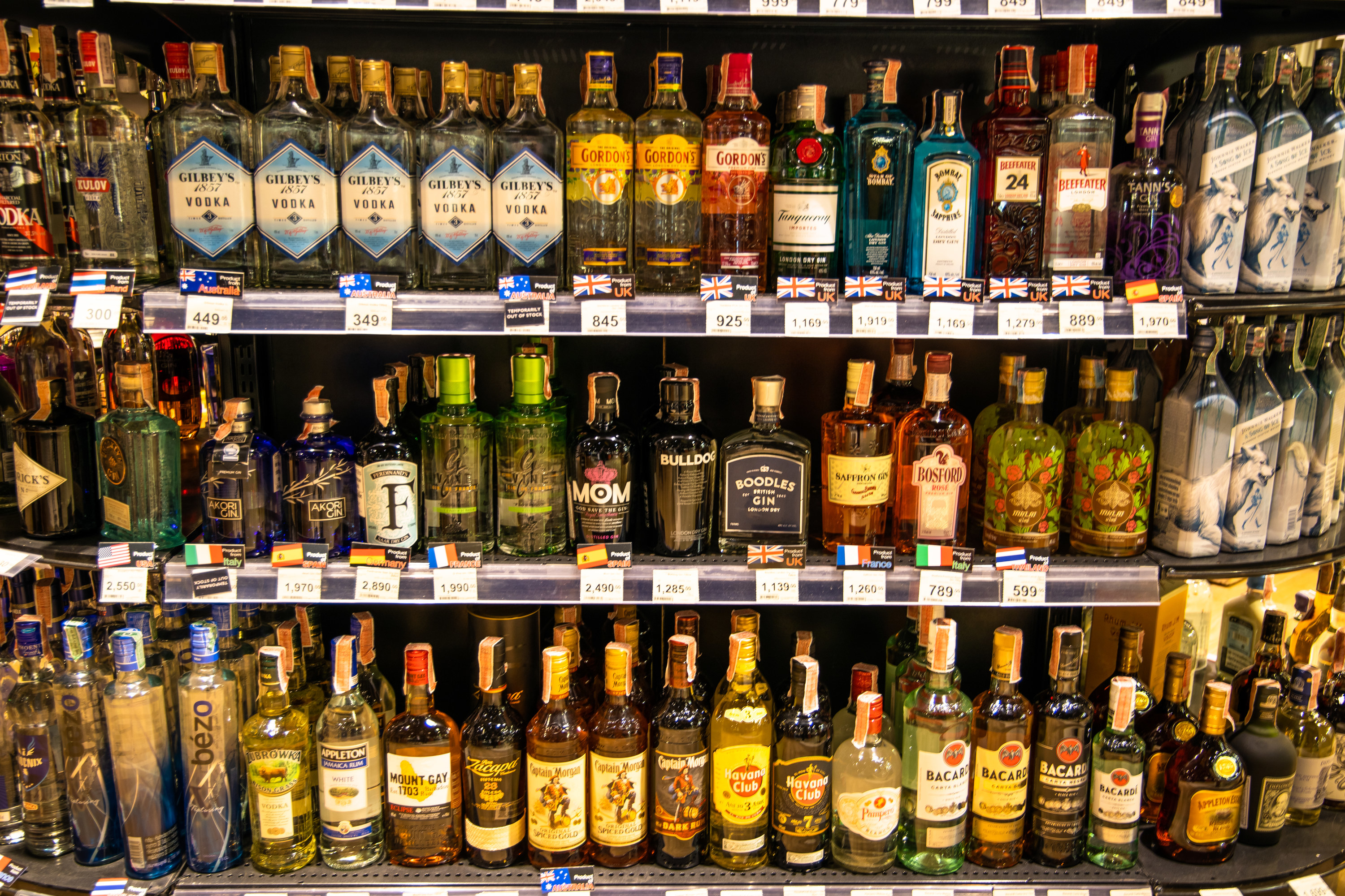 Shelves of several different types of liquor bottles