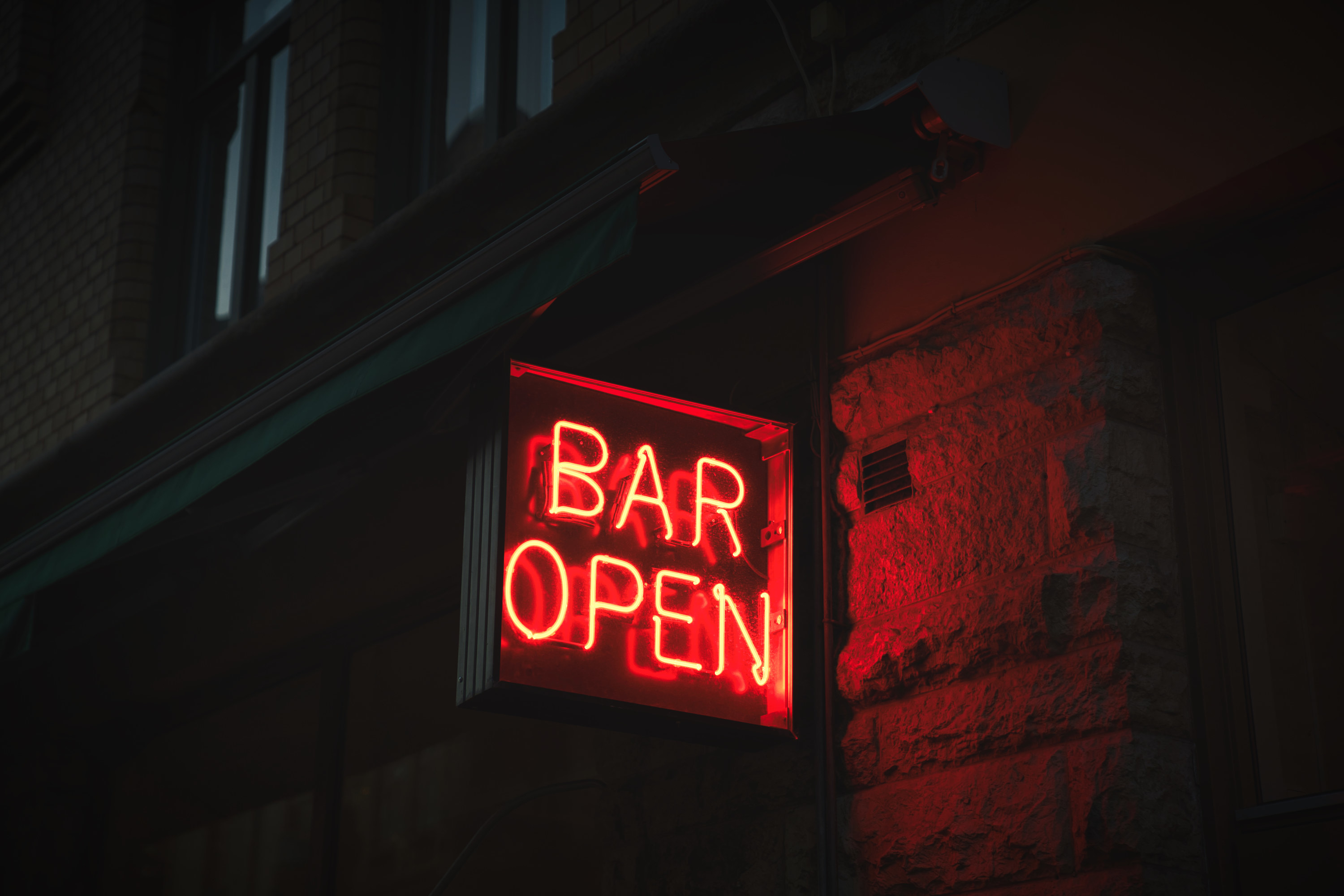 A red neon sign that reads &quot;Bar open&quot;