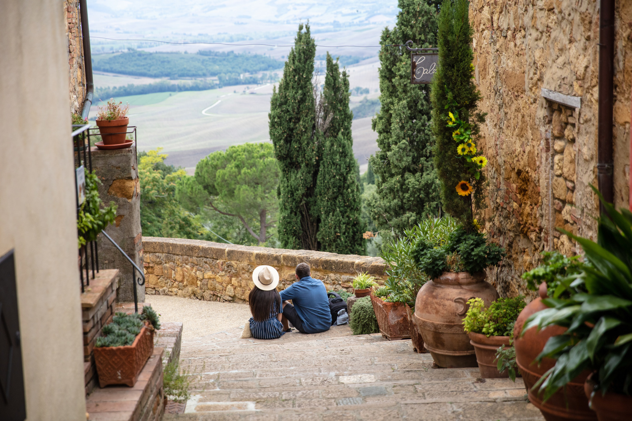 A couple sitting on the stairs enjoying the view