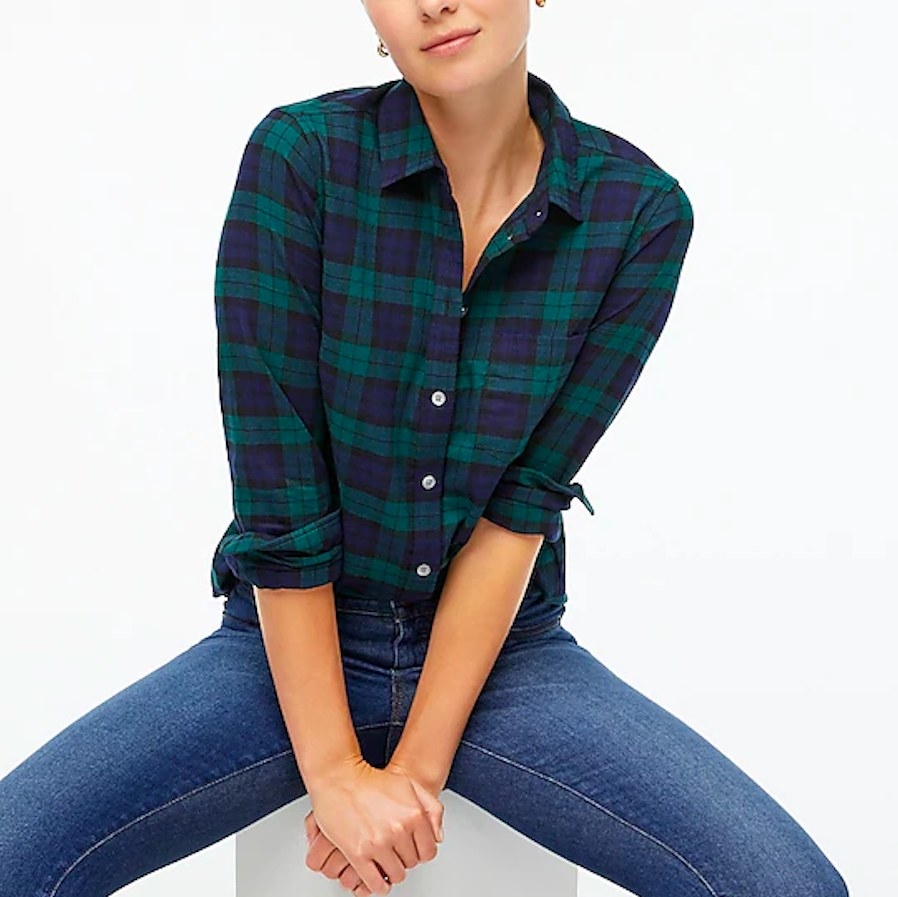 Model wearing flannel shirt and jeans