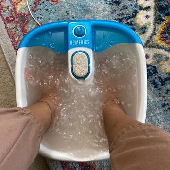 Reviewer's feet in bubbling foot spa