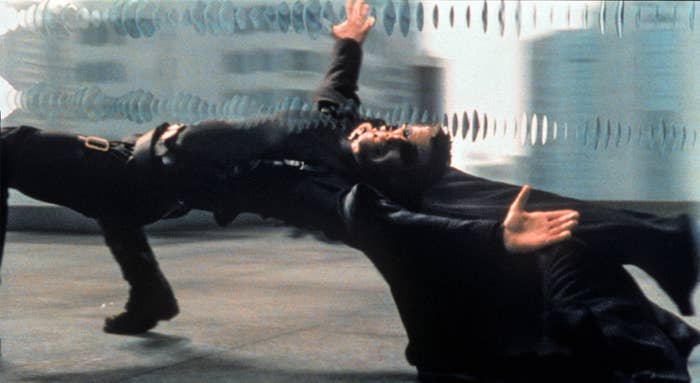 Keanu Reeves as Neo, bending backwards dodging bullets