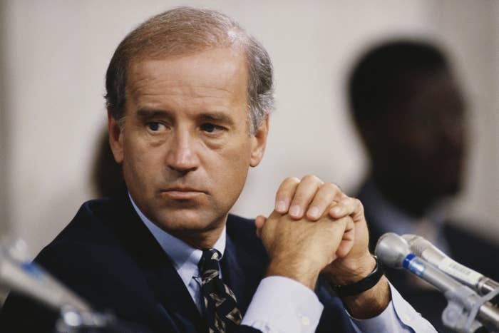 President Joe Biden sitting in front of a microphone