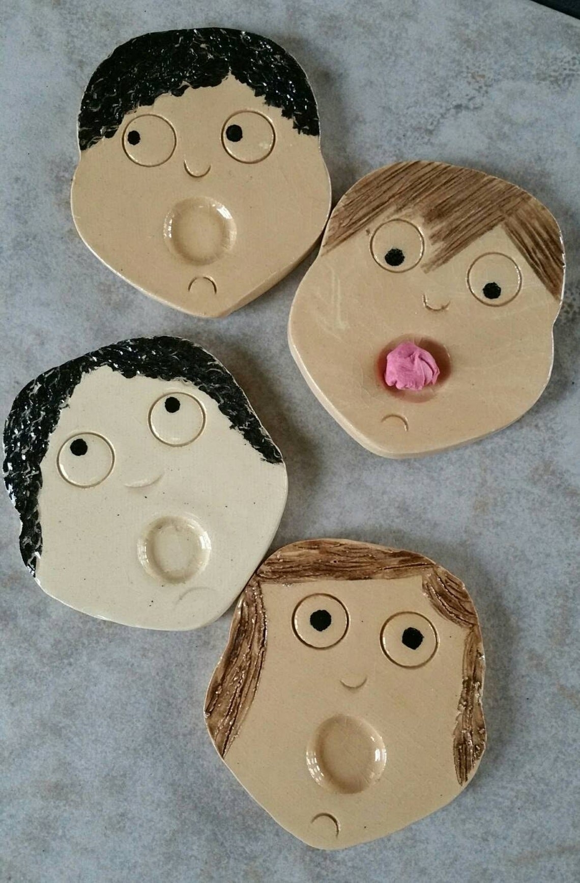 face-shaped plates with open mouths for gum to be put in