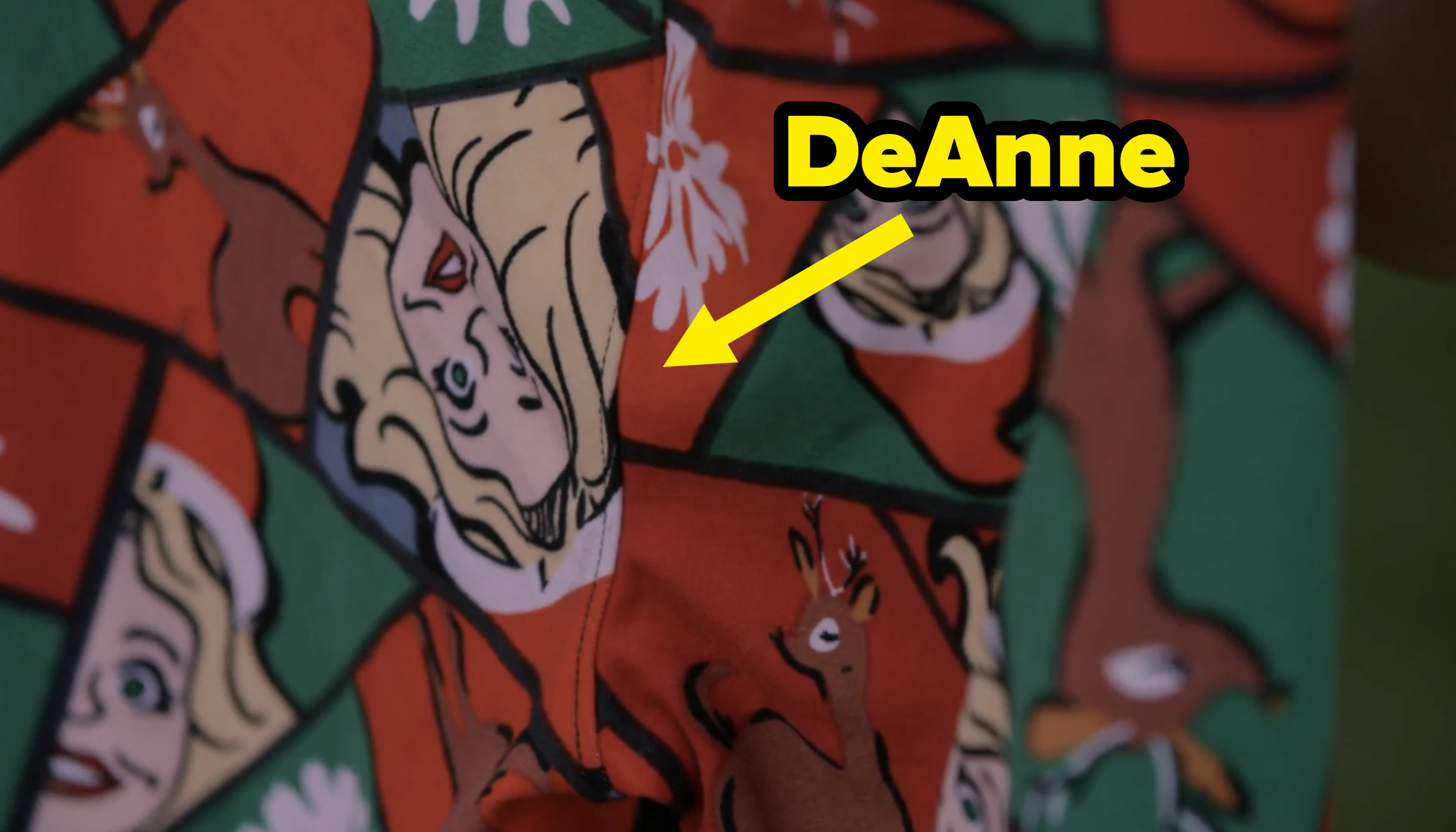 A close-up of a holiday legging with reindeer and DeAnne in a Santa hat