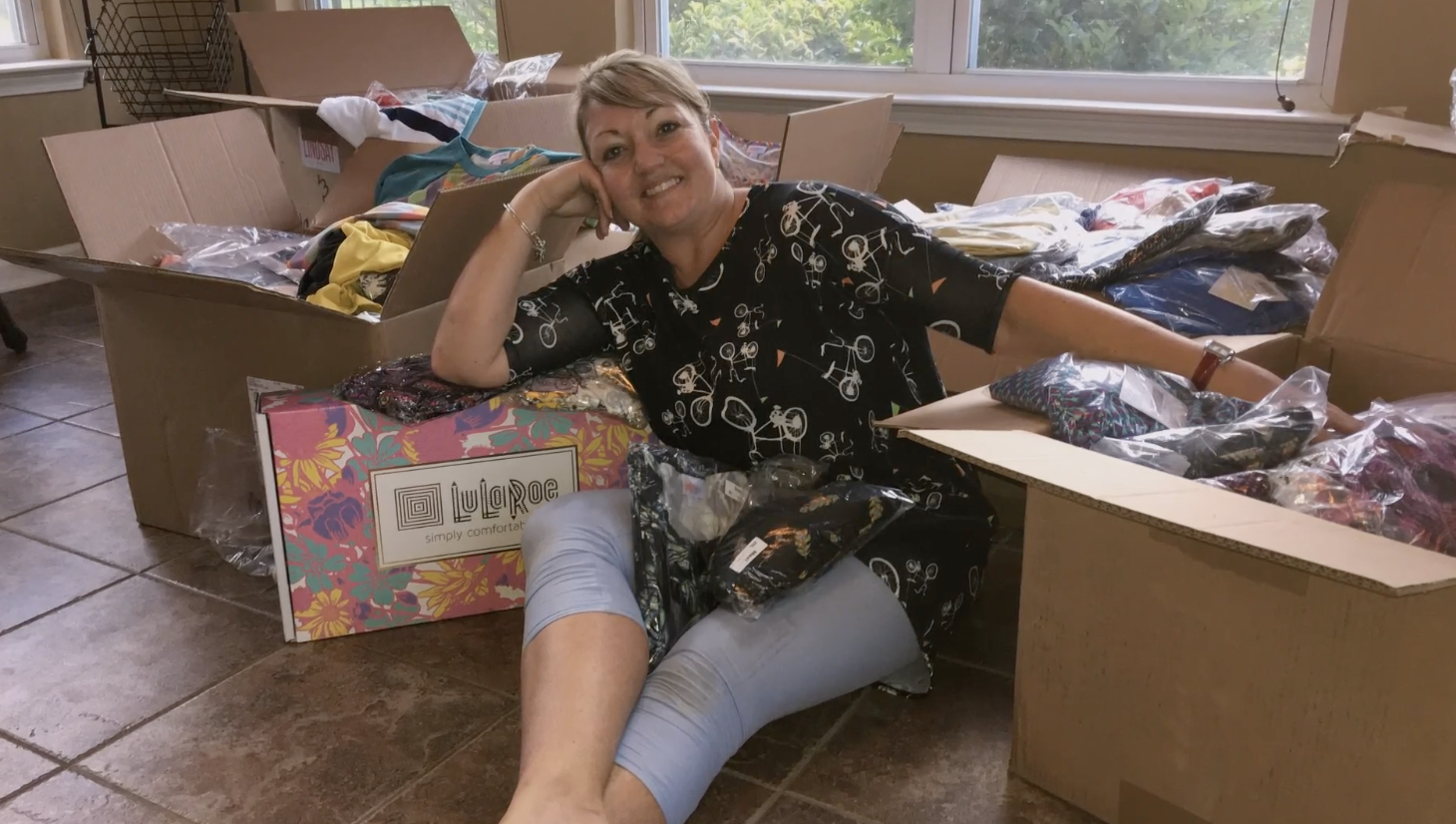 A LuLaRoe consultant with boxes and boxes of product