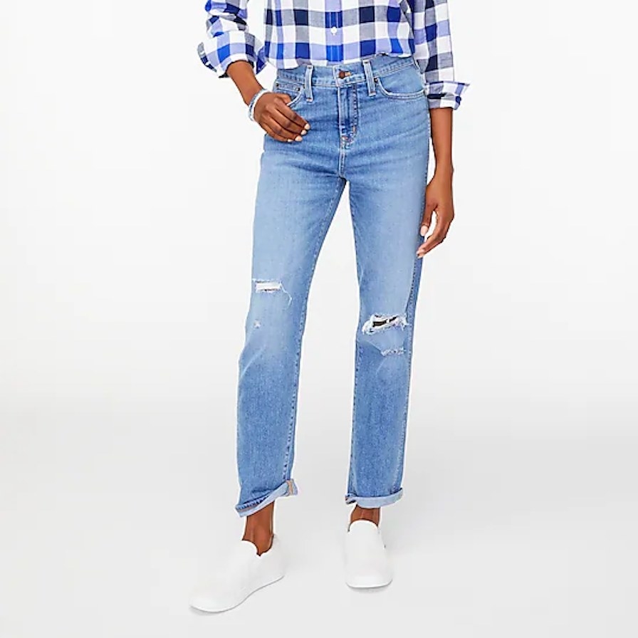 Model wearing jeans, white shoes and a plaid shirt