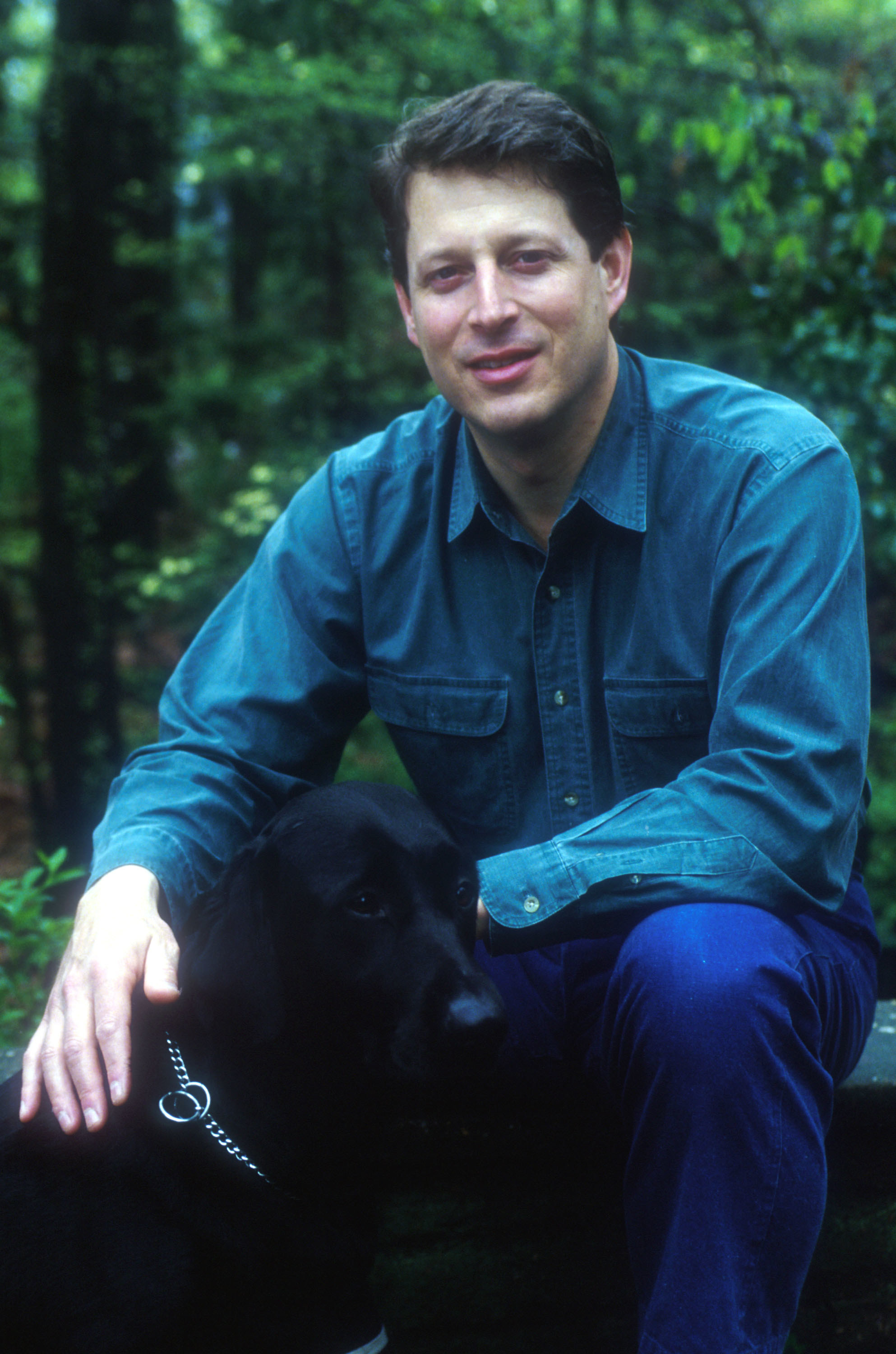 Al Gore posing with a black dog