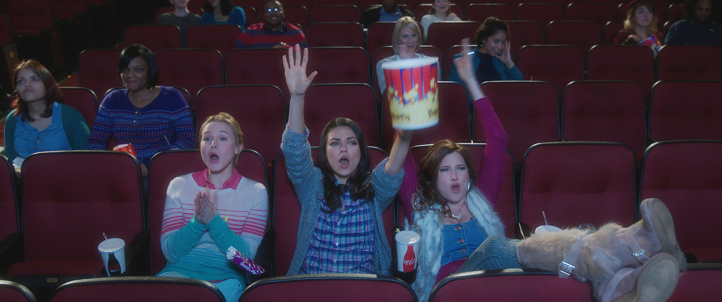 Kristen Bell, Mila Kunis, Kathryn Hahn shouting in a movie theater