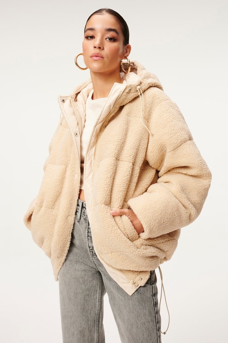 model wearing the cream colored puffer