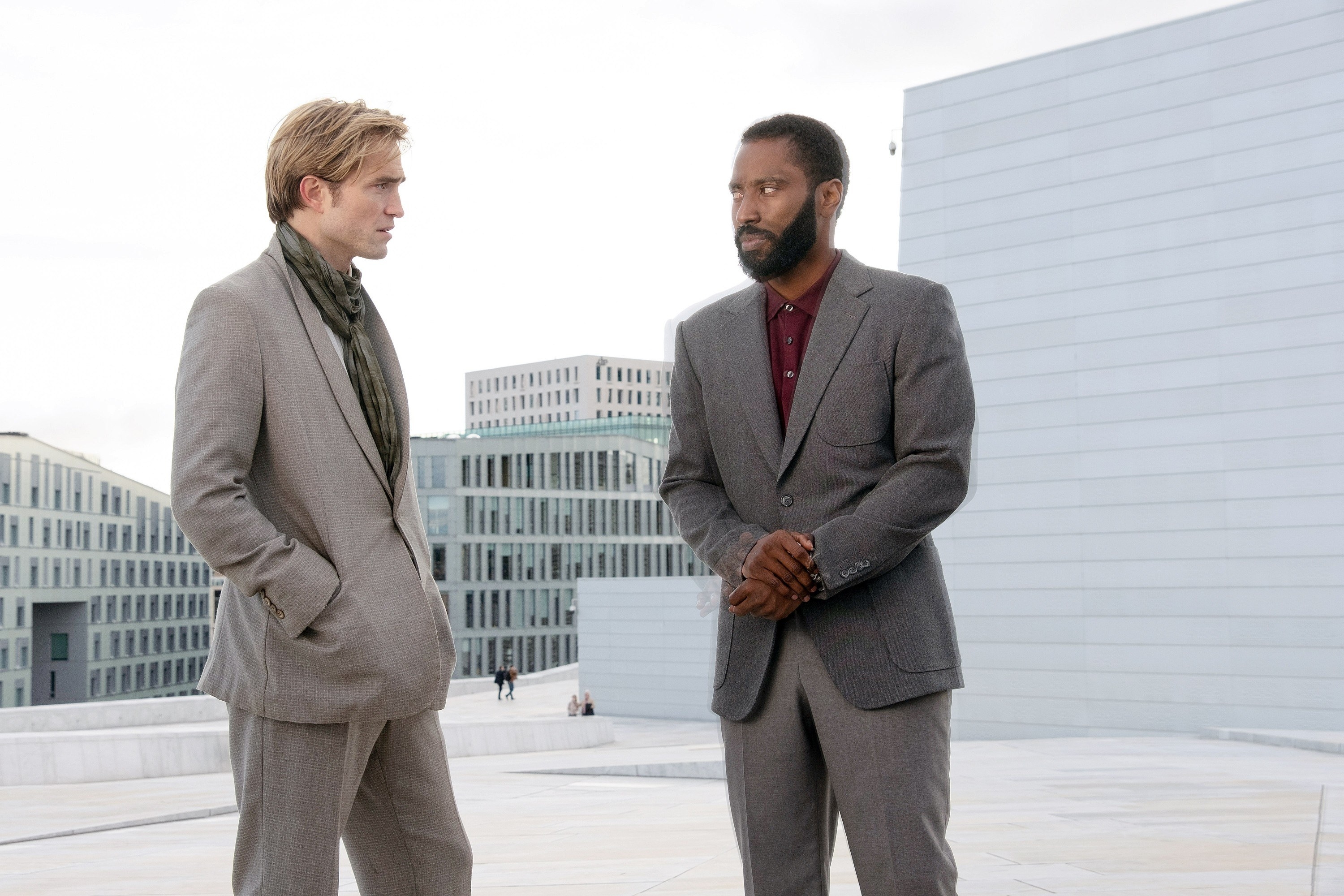 image of two men talking outside both are wearing suits