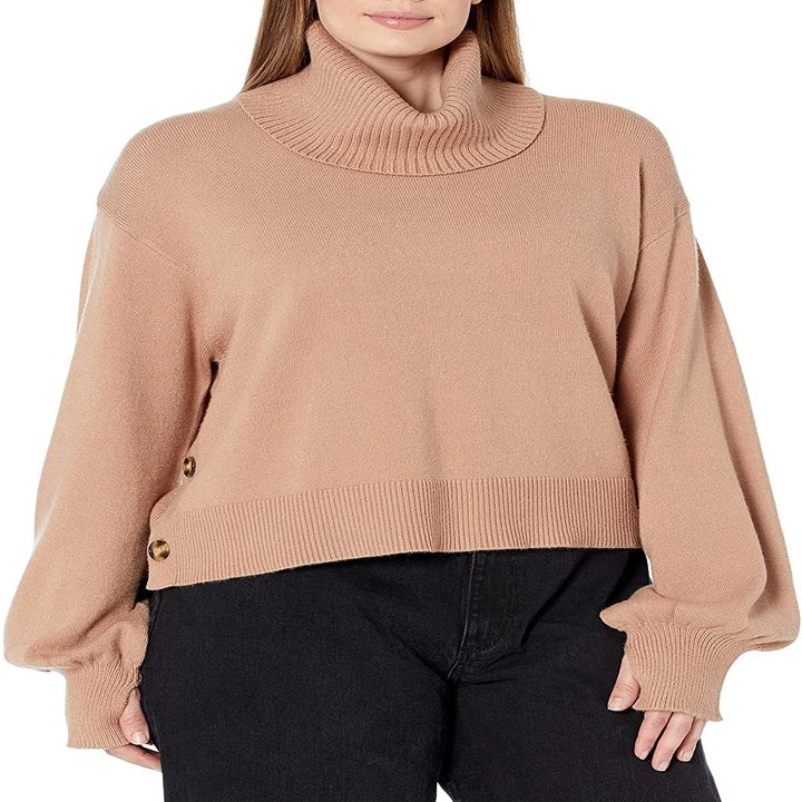 Model wearing the tan turtleneck