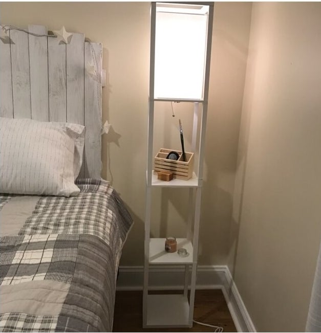 Review photo of the white floor lamp used as a night stand