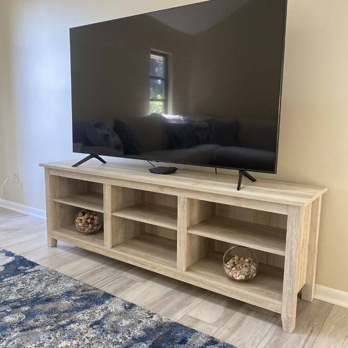 reviewer photo of the TV stand with a TV on top