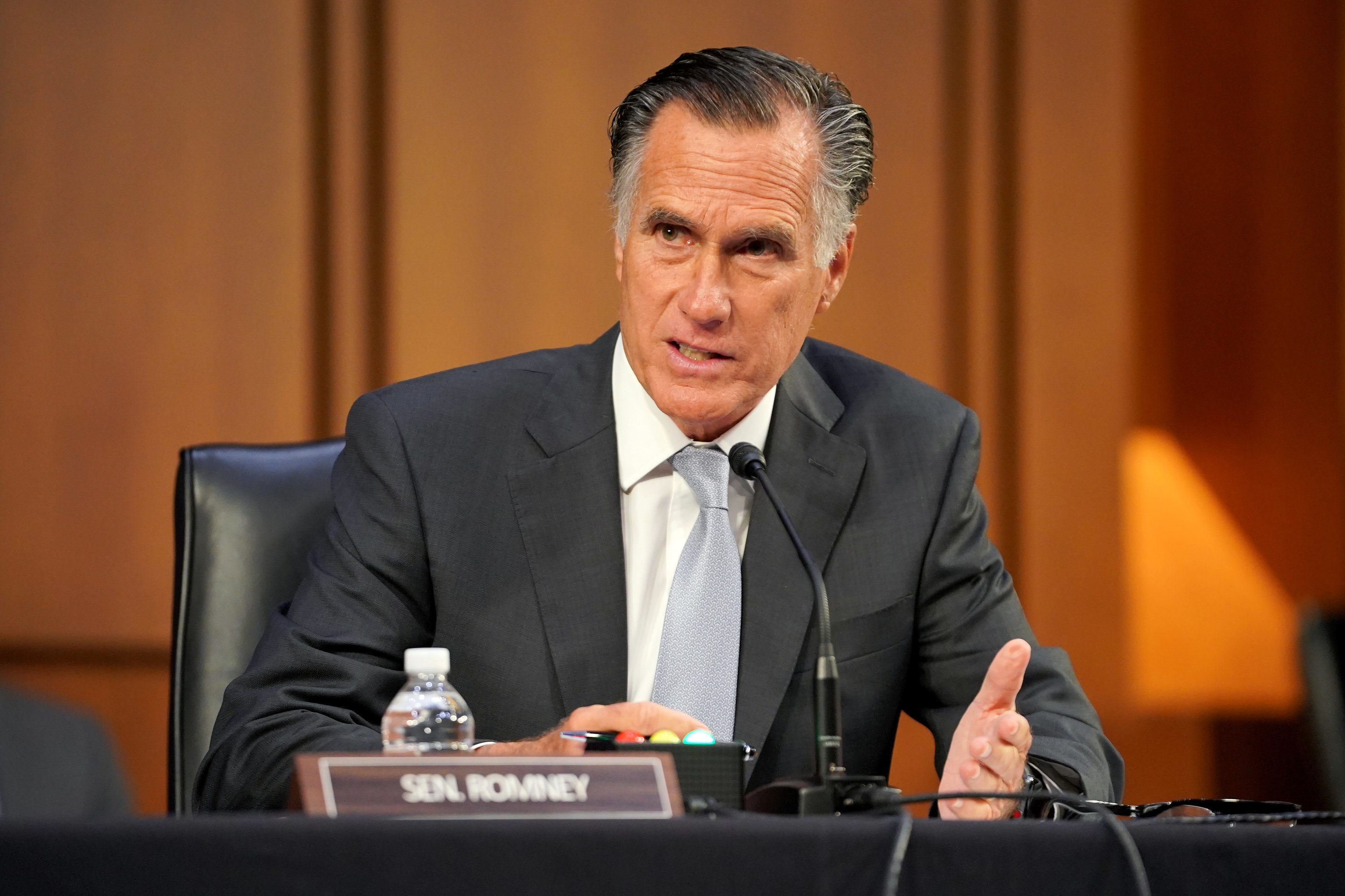 Mitt Romney speaking into a microphone