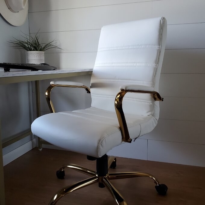 a reviewer photo of the the desk chair in white and gold