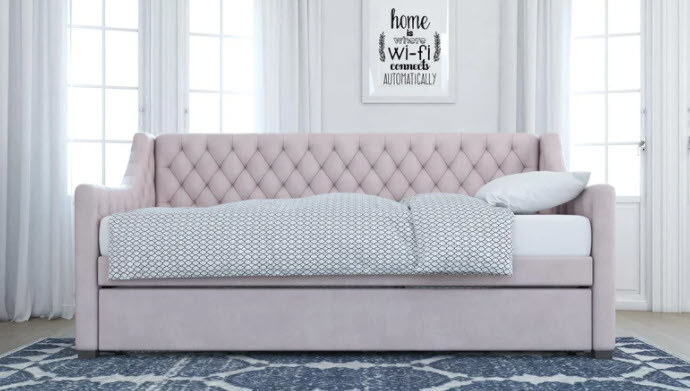 A twin daybed with trundle with a tufted headboard and angled side frames