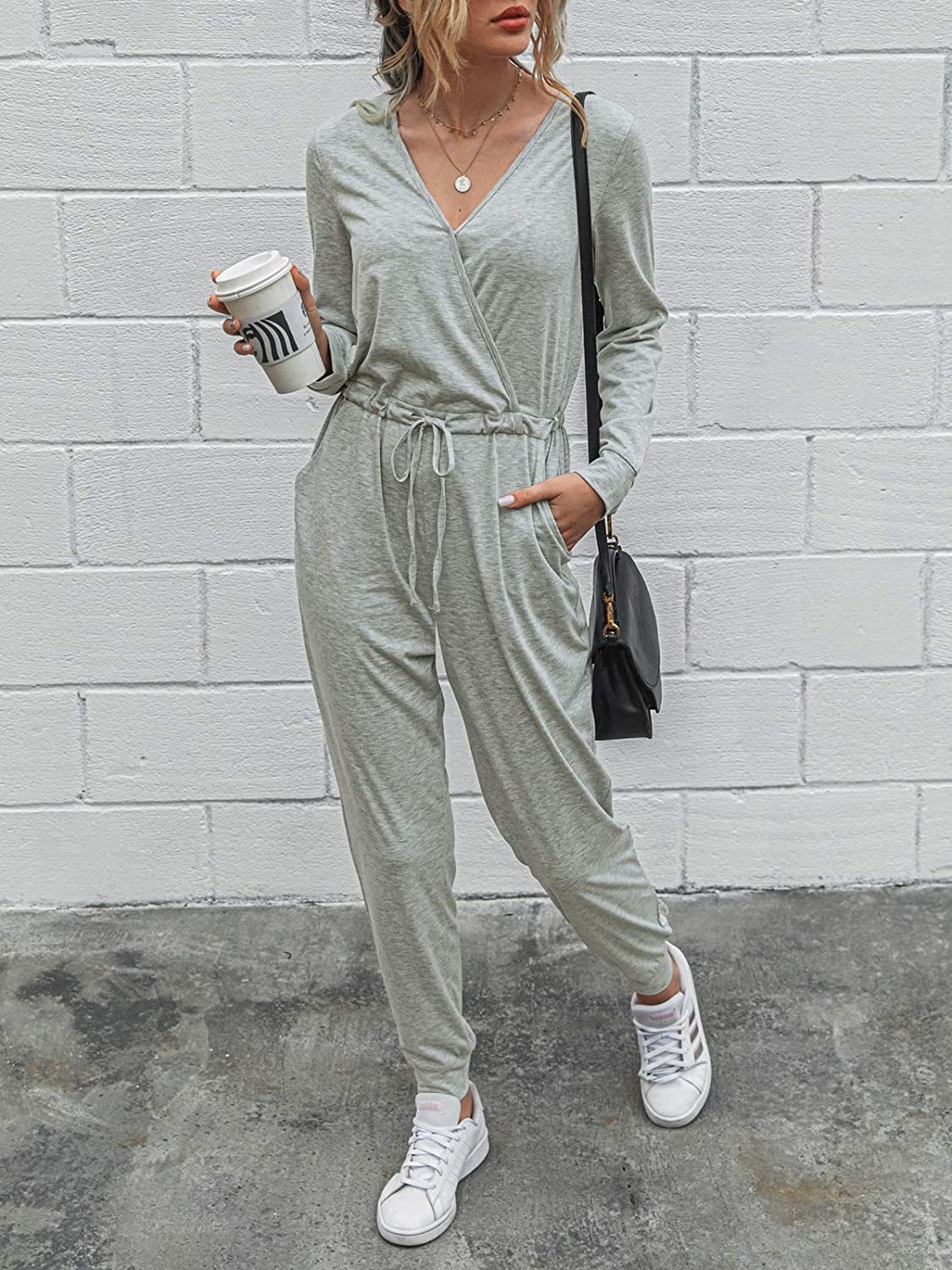 a model wears the gray jumpsuit with white sneakers