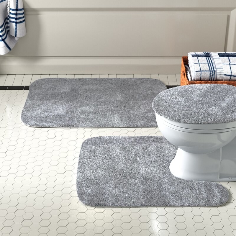 The bath rug set in a bathroom in gray