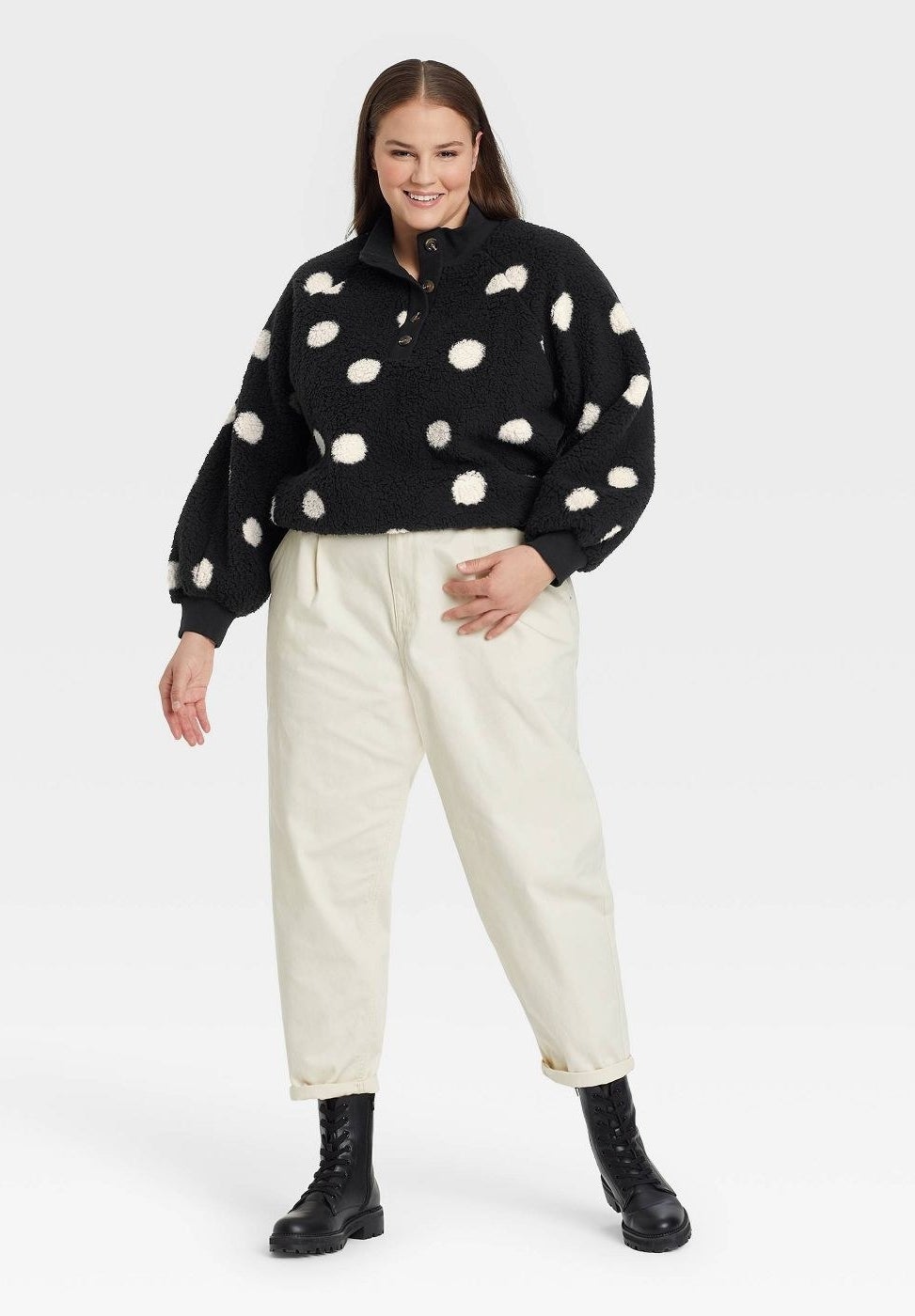 model wearing the black and white polka dot teddy pullover