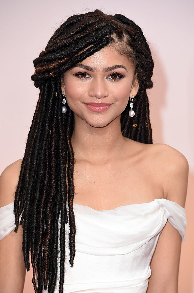 Zendaya smiling and wearing locs