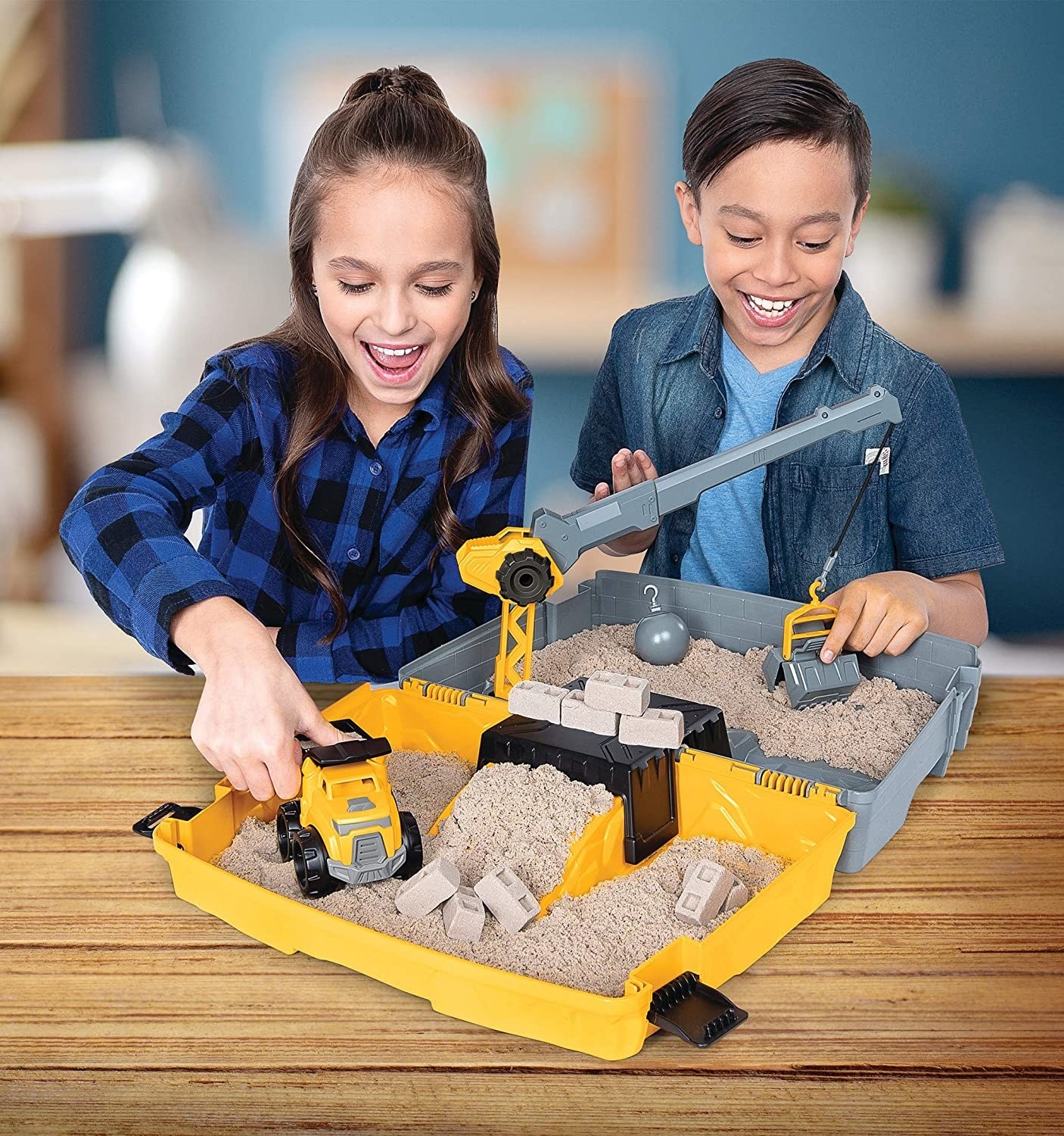 two children playing with the kinetic sand