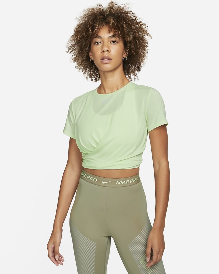 Model wearing the light green twisted top with high waisted leggings