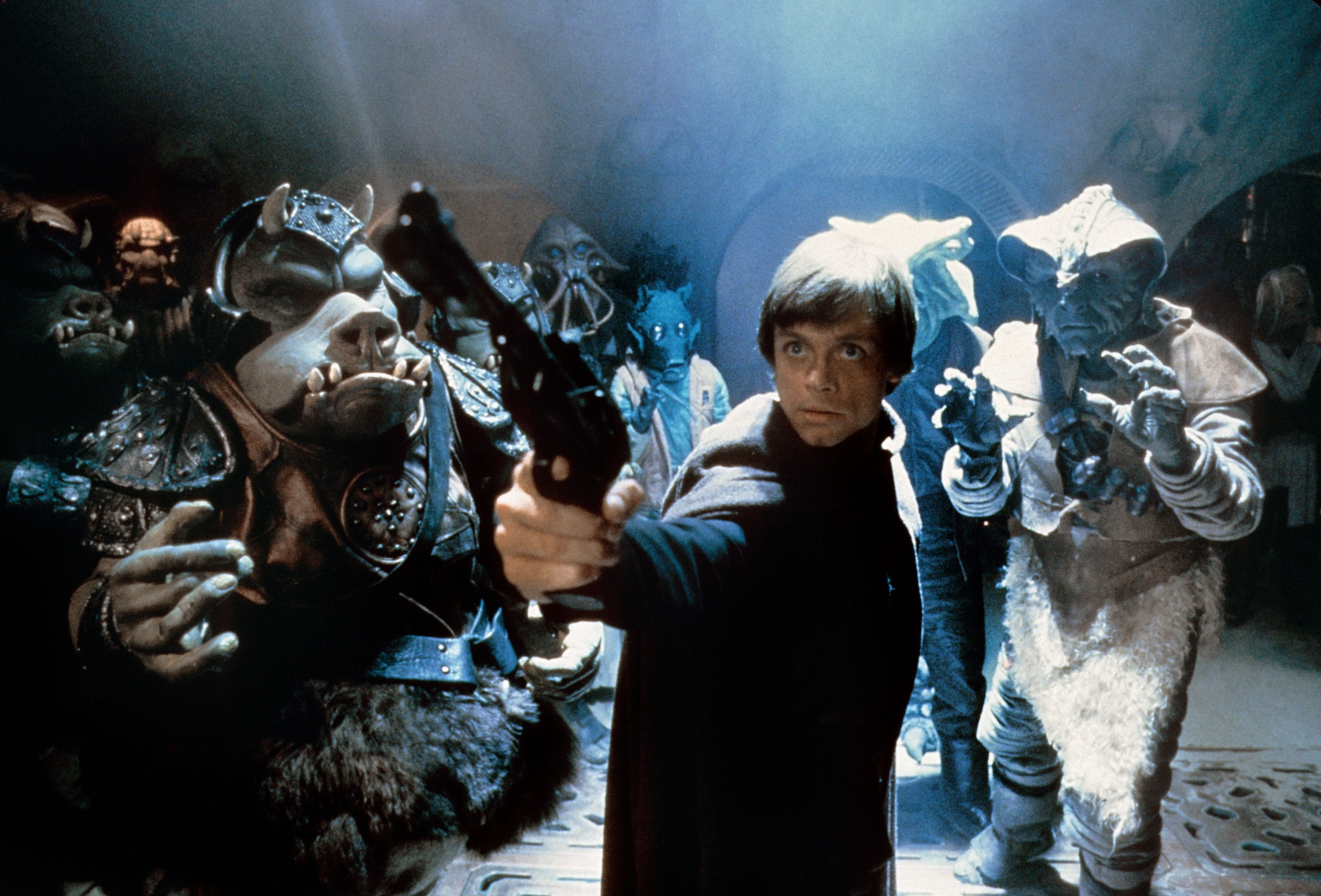 Luke pointing a gun at Jabba