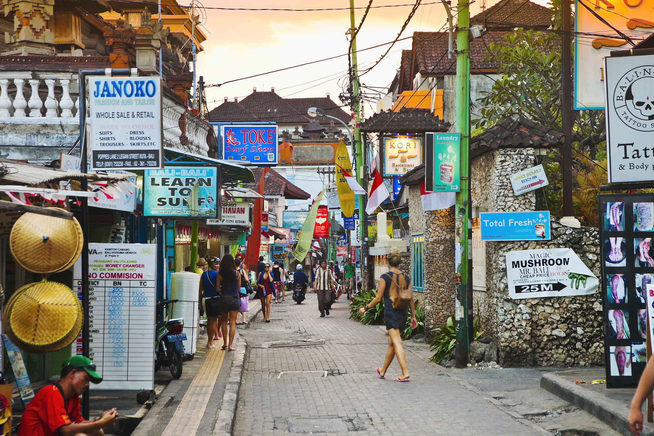 A street with lots of restaurant and shop signs