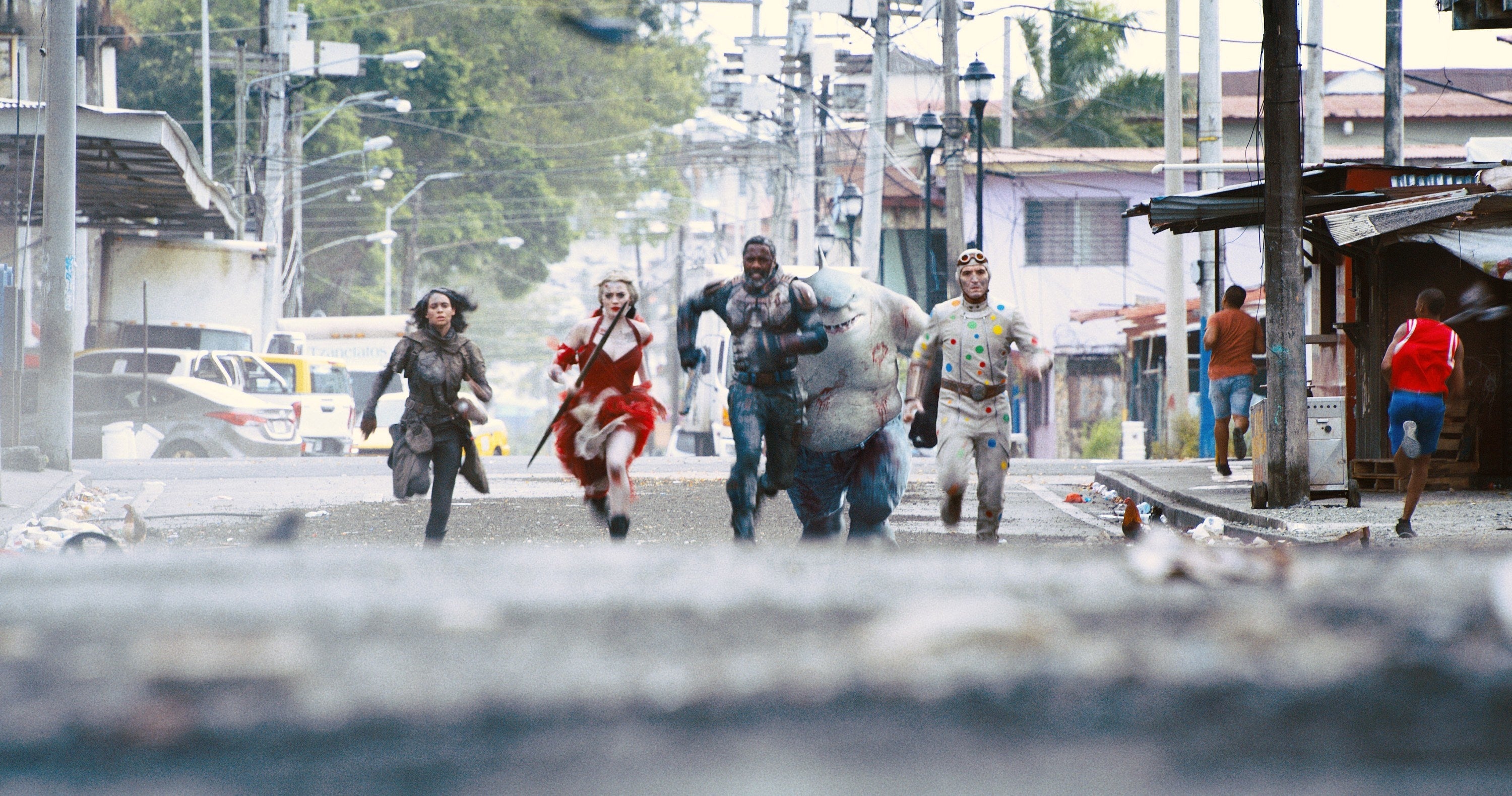 The suicide squad runs towards a monster