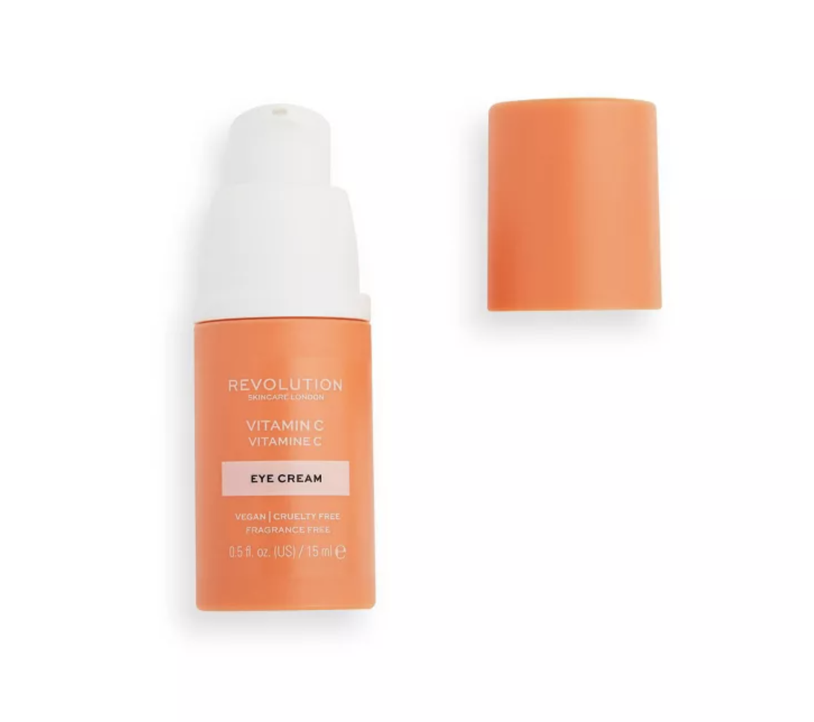 Orange and white bottle of Makeup Revolution eye cream with the cap off