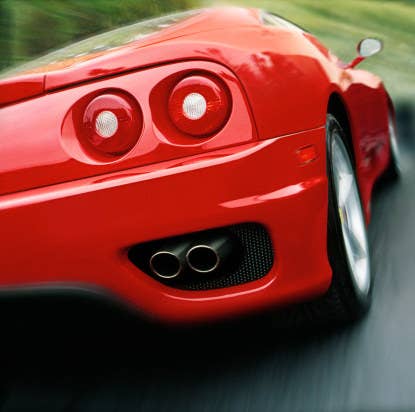 A red sports car speeds.
