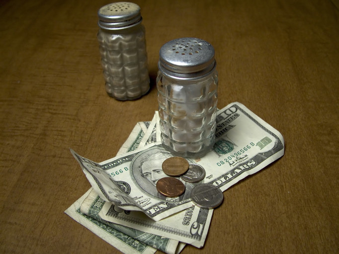 A cash tip left on a restaurant table