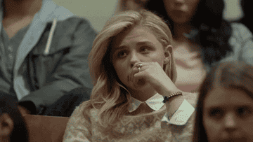 Chloë Grace Moretz looking board in a lecture hall