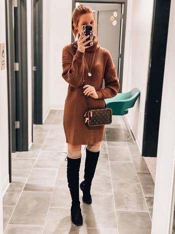 reviewer photo of them wearing the sweater dress in brown