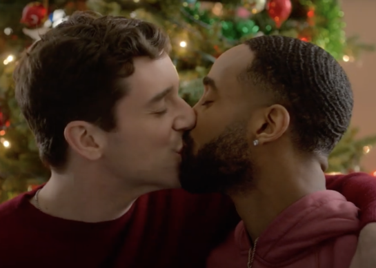The main characters kissing by the tree