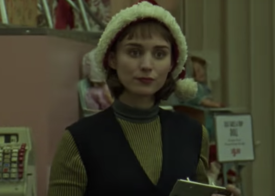 Therese at the shop, wearing a Santa hat