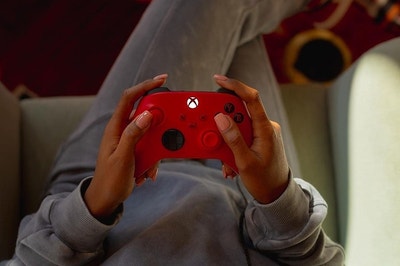 a model holding a red xbox controller