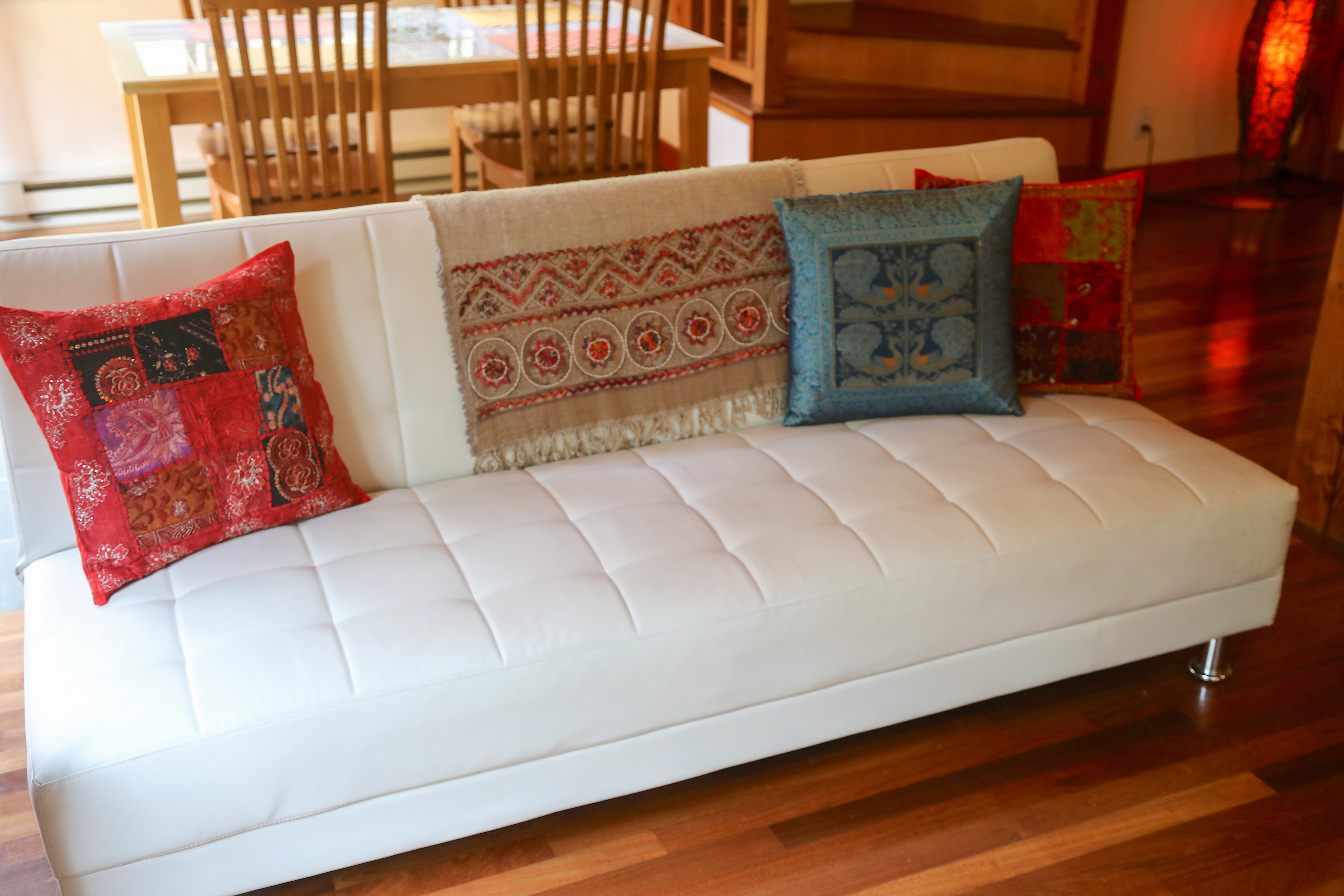 White futon with decorative pillows