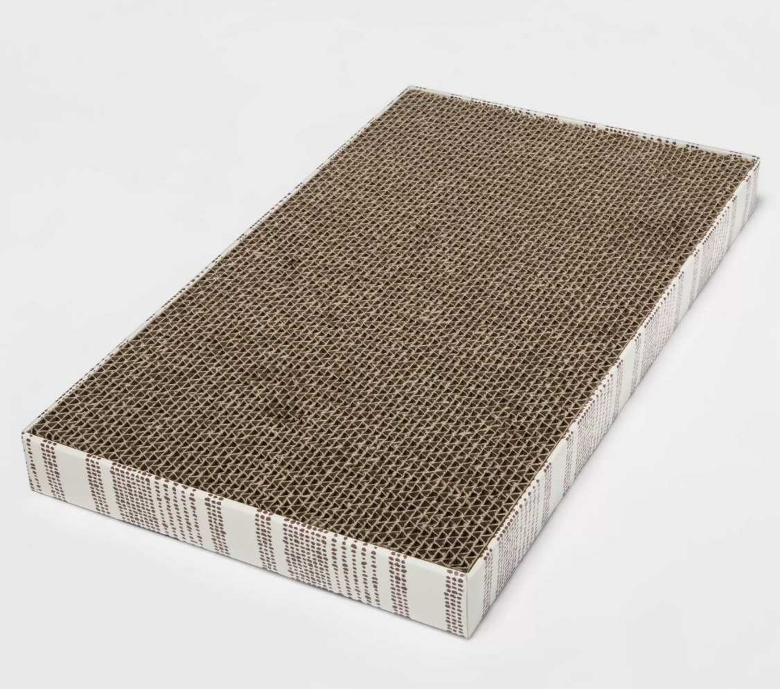 a tan scratch pad with a white and tan striped design on its sides