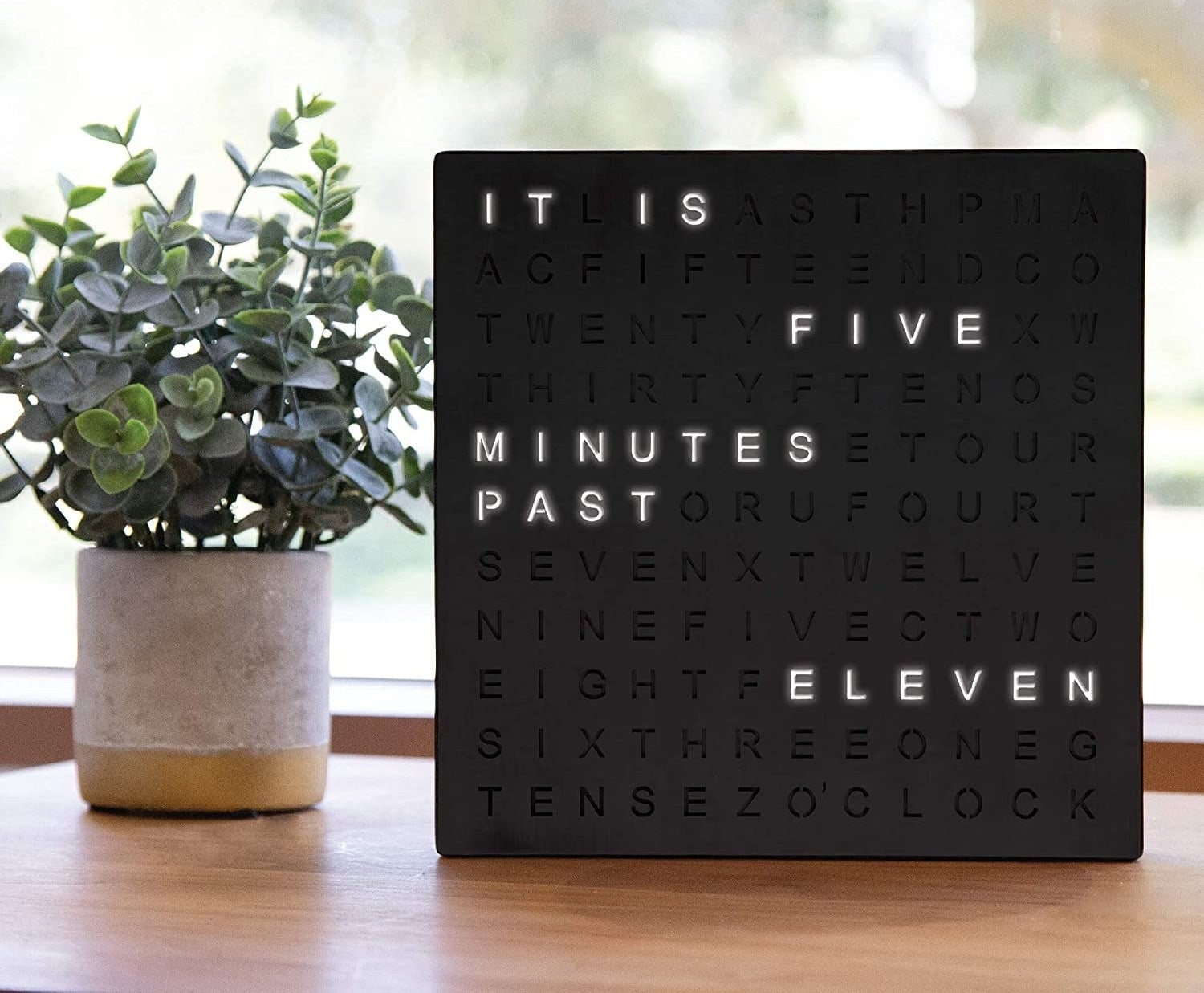 Word clock reading "it is five minutes past eleven)