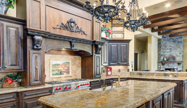 Large &quot;Tuscan&quot;-style kitchen with massive, dark wood features and dark granite countertops