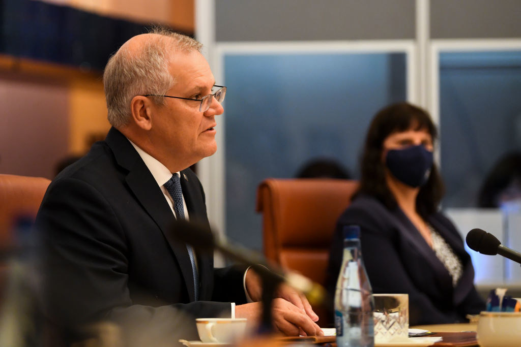 Scott Morrison sitting at a conference table
