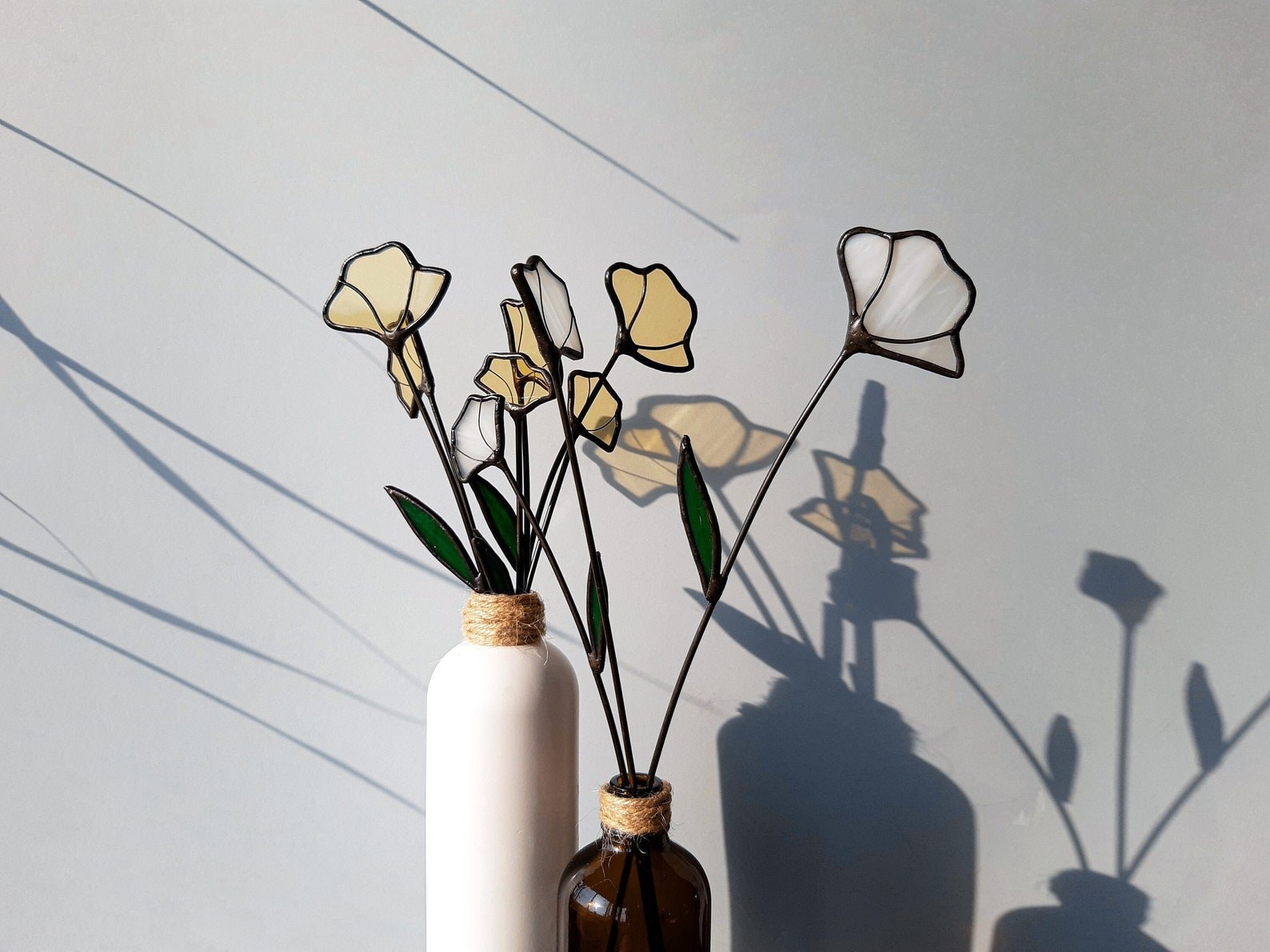 sculptural glass flowers in minimalist vases