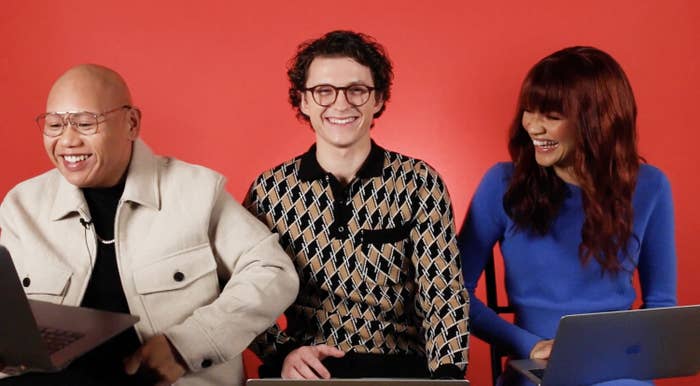 The three actors laughing as they take the quiz