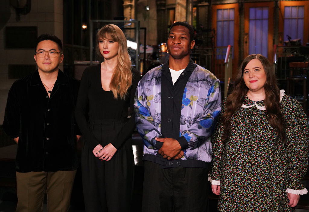 Bowen, Taylor, host Johnathan Majors, and Aidy Bryant stand on the SNL stage