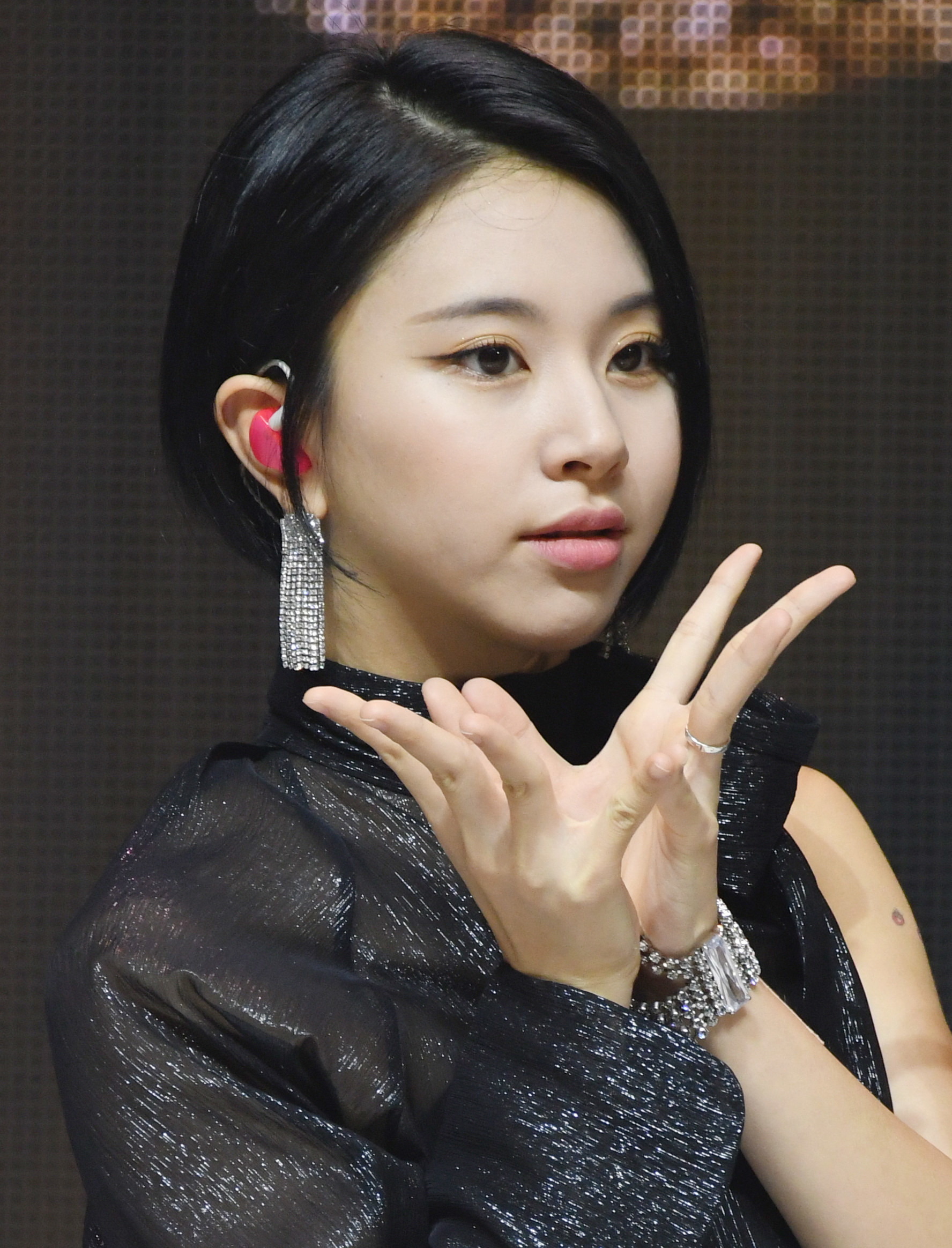 Chaeyoung holds up her hands like a flower