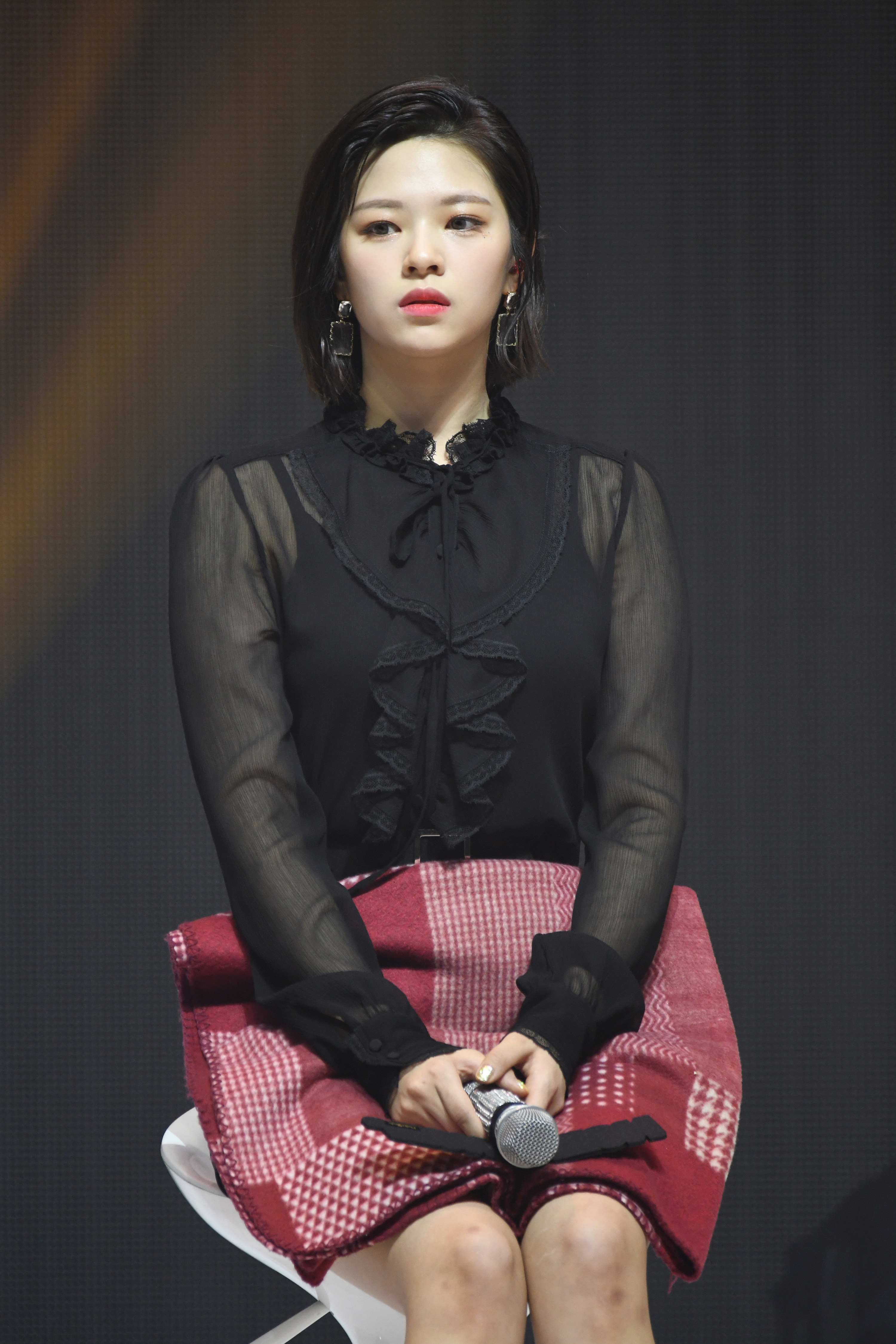 Jeongyeon sitting on stage and looking at the crowd