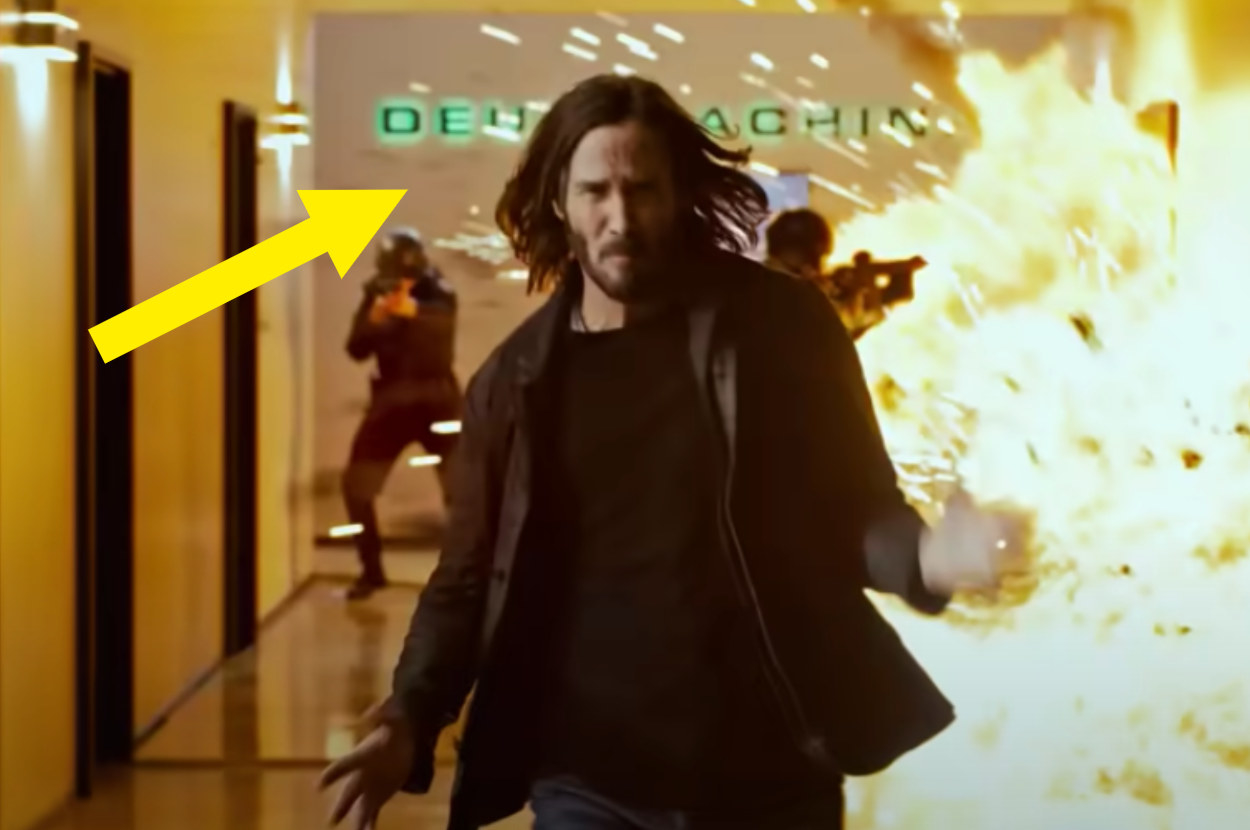 Neo running from an explosion in the Deus Machina building